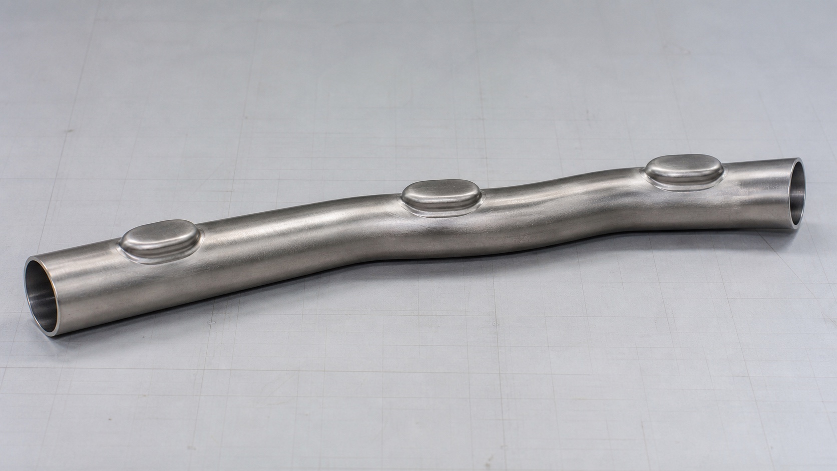 Photorealistic engineering concept of a thin-walled stainless-steel hydroformed manifold core with three closed branch bosses